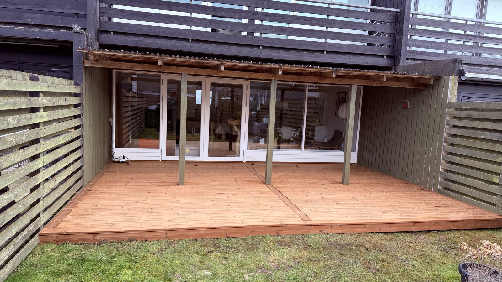 Færdig træterrasse bag hus med altan over